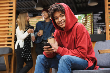 Sticker - Smiling african teenager sitting outdoors