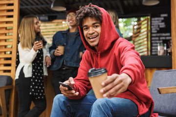 Sticker - Smiling african teenager sitting outdoors