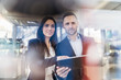 © Westend61 - Smiling businessman and businesswoman with tablet looking at a machine in modern factory