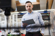 © Westend61 - Businessman using tablet at a machine in modern factory