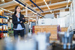 © Westend61 - Businesswoman standing in a factory looking around