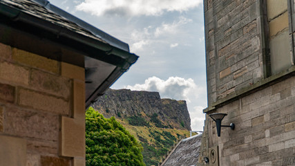 Big hill with view obstructed by two buildings