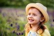 © Yakov - Cute smiling baby girl with hat outdoors in green field. Child portrait