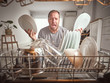 © PHILIPPE DEGROOTE/ADDICTIVE STOCK - Displeased adult male putting plate into dishwasher in stylish kitchen at home