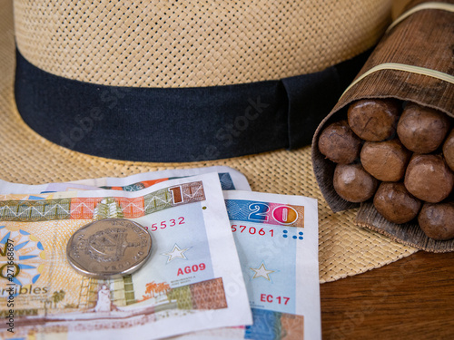 Bundle of authentic cuban cigars with panama hat and cuban peso notes and coin s Wallpaper Mural