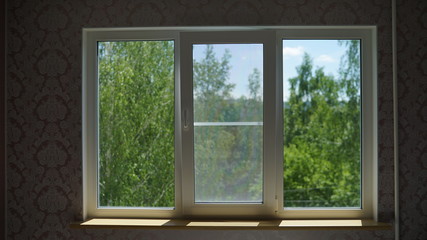 Plastic window overlooking the green trees. window overlooking mountains.