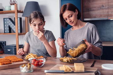 Mother and daughter having lunch at home