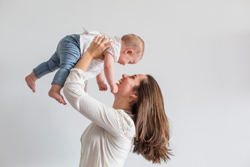 portrait of a beautiful baby girl and her mother at home. Family concept indoors. Daytime and lifestyle