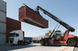 © Westend61 - Crane lifting cargo container on truck on industrial site