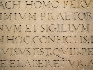 Old Latin text engraved on stone latin characters words