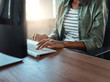 © StratfordProductions - Businesswoman typing on keyboard indoors in a modern building