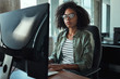 © StratfordProductions - Young african businesswoman typing on desktop keyboard