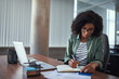 © StratfordProductions - Businesswoman writing in an agenda on a desk at office