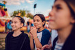 © kerkezz - Friends hang out at amusement park