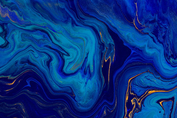 hand painted background with mixed liquid blue and golden paints. abstract fluid acrylic painting. m