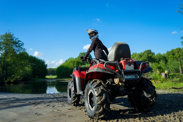 Outdoor activity. Quad bike rides. Extreme sport. Nature, forest, river.