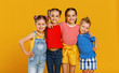 © JenkoAtaman - group of cheerful happy children on colored yellow background.