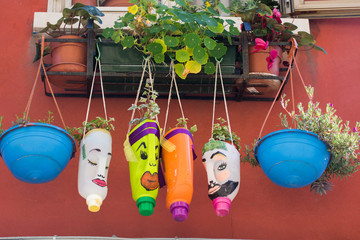 funny flowerpot.,flowers in plastic bottles, in Murano, Venice, Italy, 2019