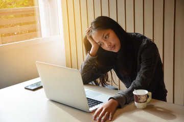 A girl students, She is serious face about making reports, sending teachers. on the laptop