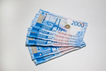 Many new banknotes are two thousand Russian rubles. Cash paper money on a white background.