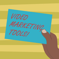 Text sign showing Video Marketing Tools. Conceptual photo Technique used to increase audience engagement Drawn Hu analysis Hand Holding Presenting Blank Color Paper Cardboard photo