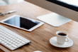 © NDABCREATIVITY - Office desk with computer, tablet and cup of coffee