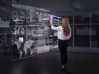 Wall Mural - back view of businesswoman working with virtual panel
