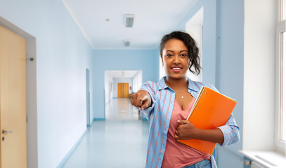 Sticker - education and people concept - happy african american young student woman with notebooks over school corridor background