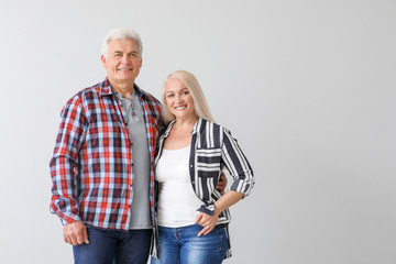 Poster - Portrait of happy mature couple on light background