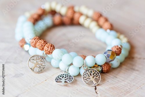 Cuadros en Lienzo Mineral stone amazonite and tree pendant bead bracelet on natural wooden backgro