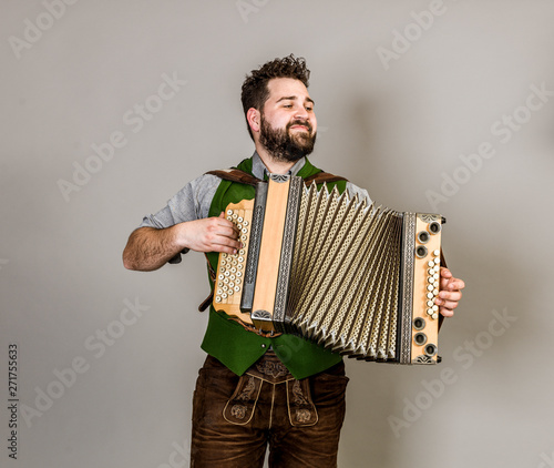 Cuadros en Lienzo cool young musician with black beard and leather trousers and traditional costum