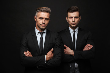 Two confident handsome businessmen wearing suit