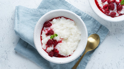 Rice Pudding. Long banner, Vegan Coconut diet breakfast with coconut milk, raspberry, scandinavian minimalism, top view, copy space