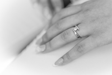 engagement ring of the girl's hand in black and white. wedding ring of a woman's hand. ring and beautiful manicure.