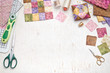 Bright square pieces of fabric, patchwork tools, sewing equipment, traditional quilting