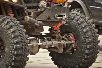 Dirty parts of a truck close up. Elements of the engine and suspension. Winch and rope on an SUV.