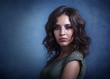 © yana_kallas - Beautiful makeup brunette model with curly hair looking sexy on gray-blue dark background. Close-up of a woman portrait.