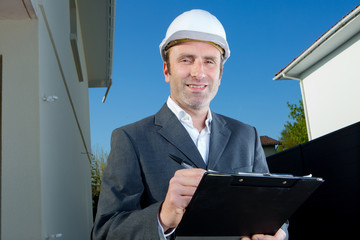 worker inspector holding clipboard