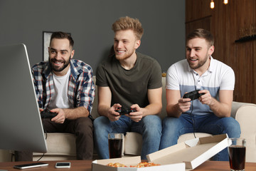 Wall Mural - Emotional friends playing video games at home