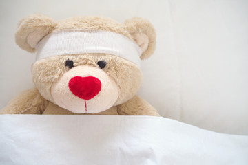 Wall Mural - The teddy bear has gauze on the head. Child Injury Concept