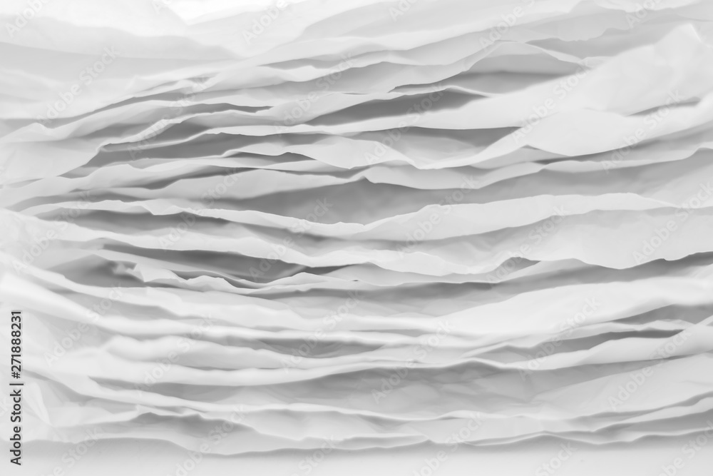 Closeup of gray paper layers stack. Wavy lines abstract art background. Copy space. - obrazy, fototapety, plakaty 
