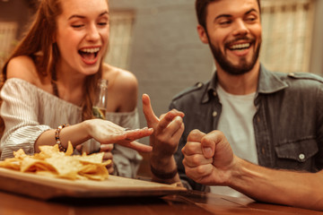 Wall Mural - Close-up photo of friends sharing a laugh and playing games