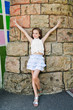 Portrait of adorable smiling little girl child schoolgirl teenager having fun outdoors