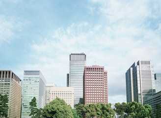 A group building with tree and road in a modern city in Tokyo. - Image