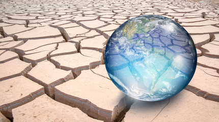 Poster - Global warming concept - Glass Globe (Planet Earth) on dry soil 