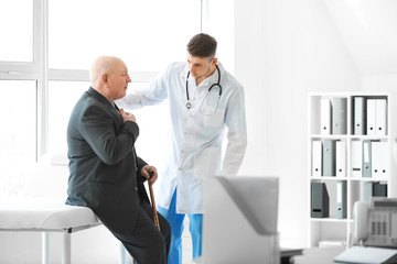 Wall Mural - Doctor examining senior man in nursing home