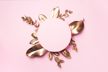 Wall Mural - Golden leaves on pink background with copy space. Top view. Copy space. Summer and autumn concept. Creative design elements for invitation, wedding cards, valentines day, greeting cards.