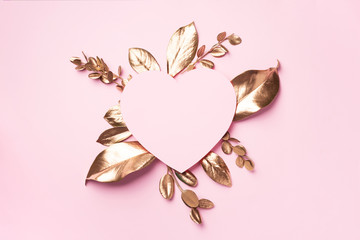 Wall Mural - Golden leaves, heart shaped paper on pink background with copy space. Top view. Copy space. Summer and autumn concept. Creative design elements