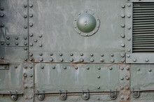 Texture Of Tank Side Wall, Made Of Metal And Reinforced With A Multitude Of Bolts And Rivets