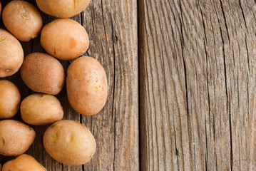 Canvas Print - petite potatoes on rustic wood table background